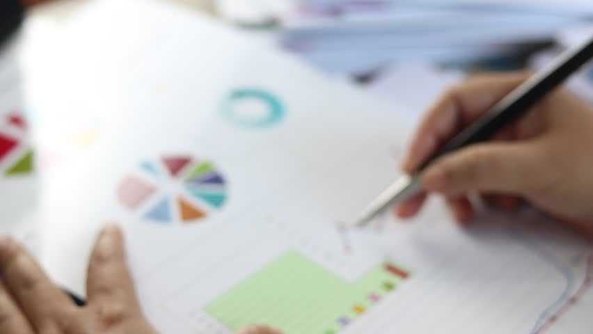 Policy And Plan Analyst Are Analyzing Data From Graphs In Order To Improve Their Performance Business And Education Concept