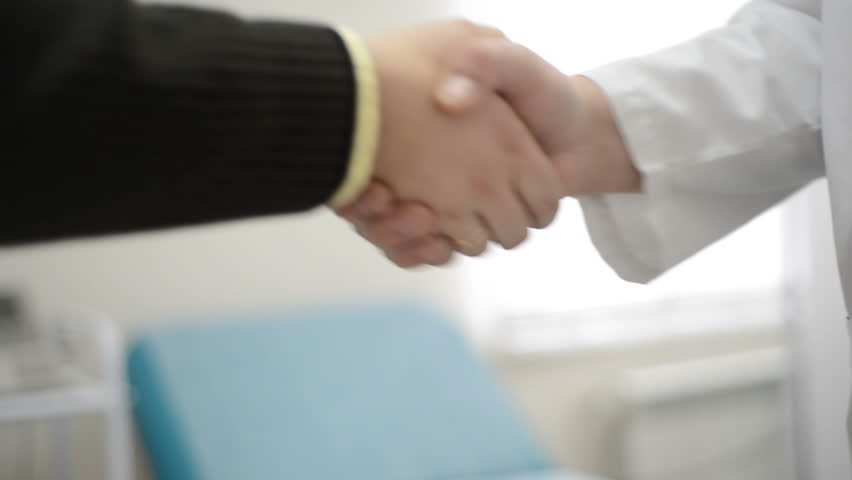 Qualified Doctor And Grateful Patient Shaking Hands Handshake Healthcare Services At Clinic