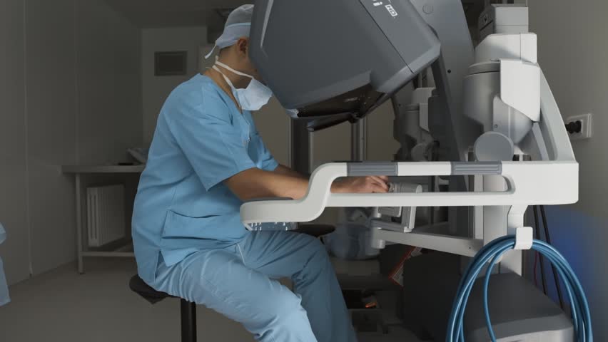 Surgeon Operating Medical Robotic Surgery Device Professional Surgeon Perform Remote Manual Control Of Robotic Arm And Manipulators Minimally Invasive Surgical System Modern Medicine Medical Robot