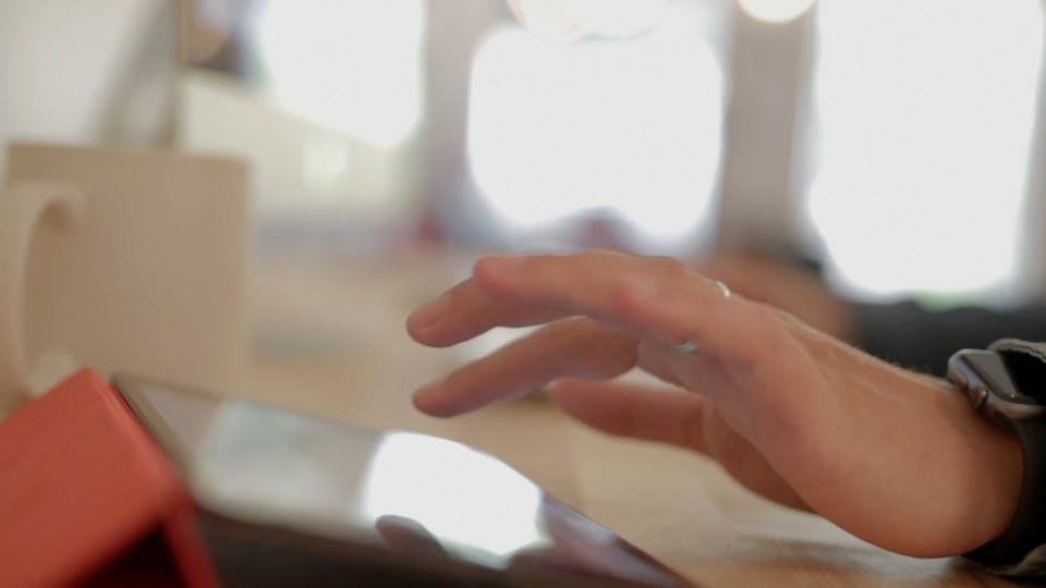 Person Swiping And Typing On Keyboard